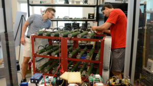 Alex Nowinski, left, and Tim Sonnenberg are ready to test a power converter they designed to help cool a resistor load bank in FREEDM’s Green Energy Hub. Photo by Marc Hall.